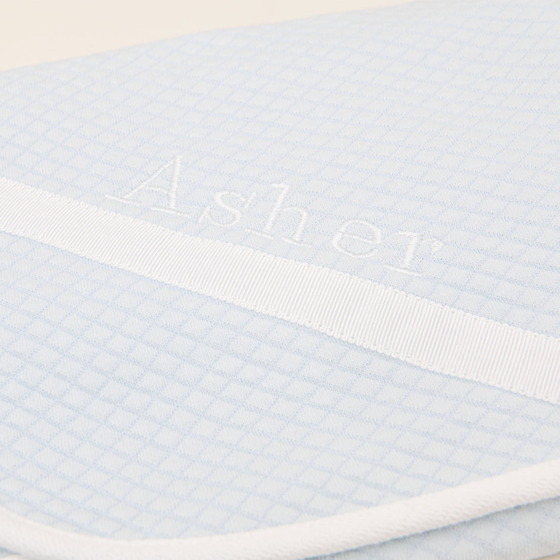 Close detail of the corner of the Asher Personalized Blanket in powder blue.