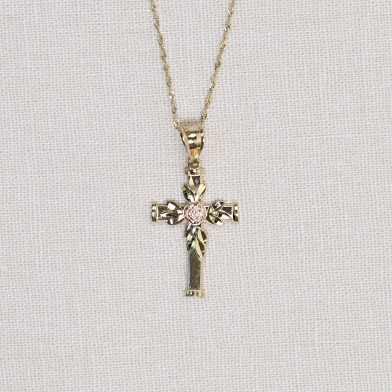 Solid gold cross with gold leaves and rose gold rose detail on chain