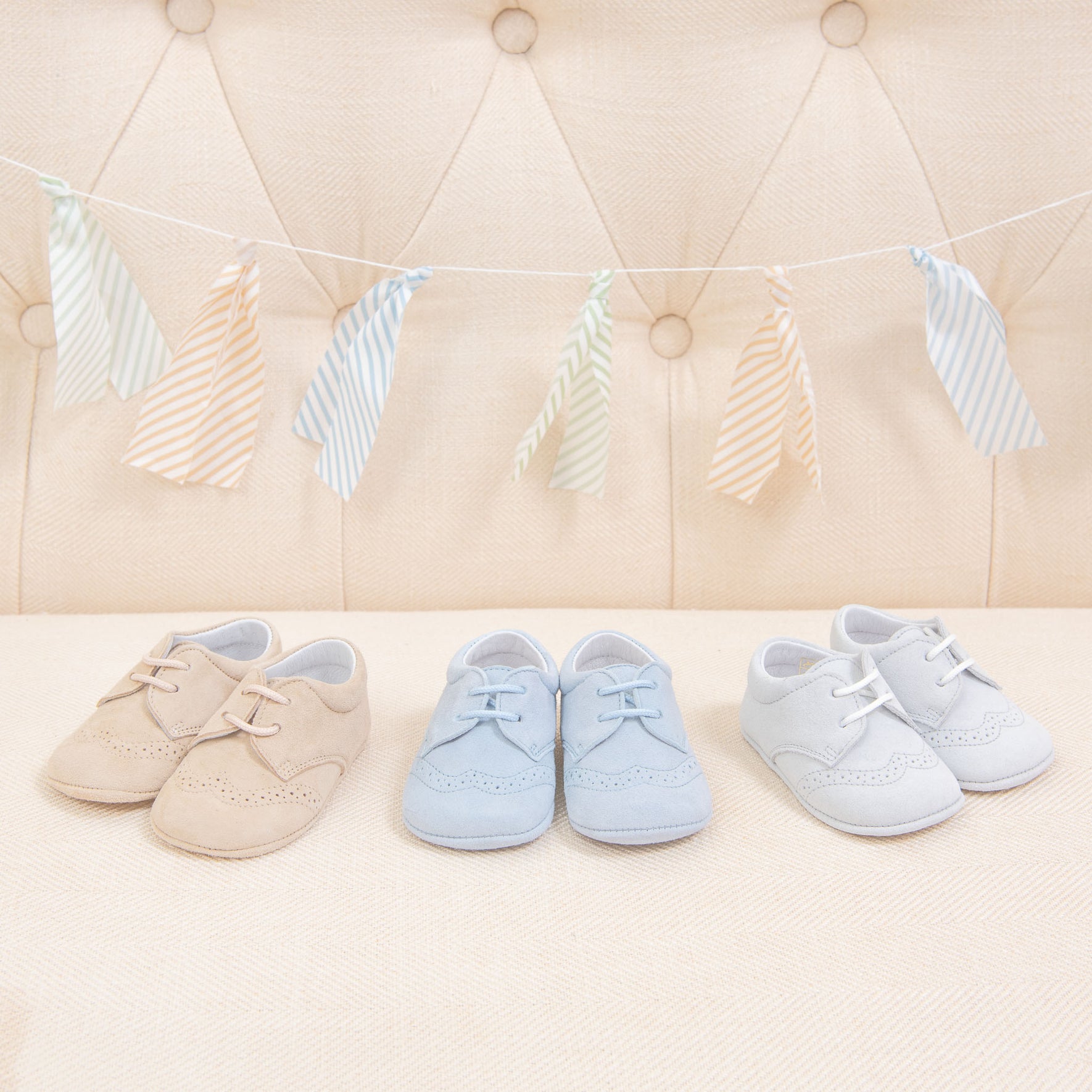 Flat lay photo of three pairs of Theodore Suede Shoes. Made from 100% suede with detailed edging. Available in colors blue, grey, and tan.