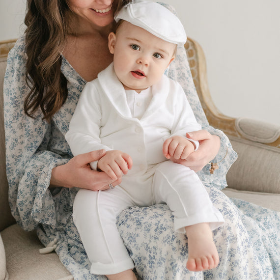 Baby boy sitting on his mother's lap. He is wearing the Miles 3-Piece Suit, including the jacket, pants, and onesie
