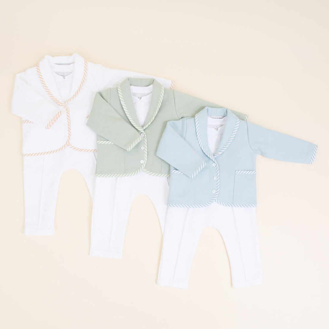 Flat lay photo of three different Theodore 3-Piece Suits, including the colors tan, green, and blue.