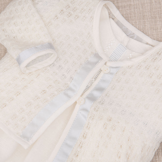 A knit baptism sweater, part of the Rowan collection. Made with super soft knit and lined with blue silk.