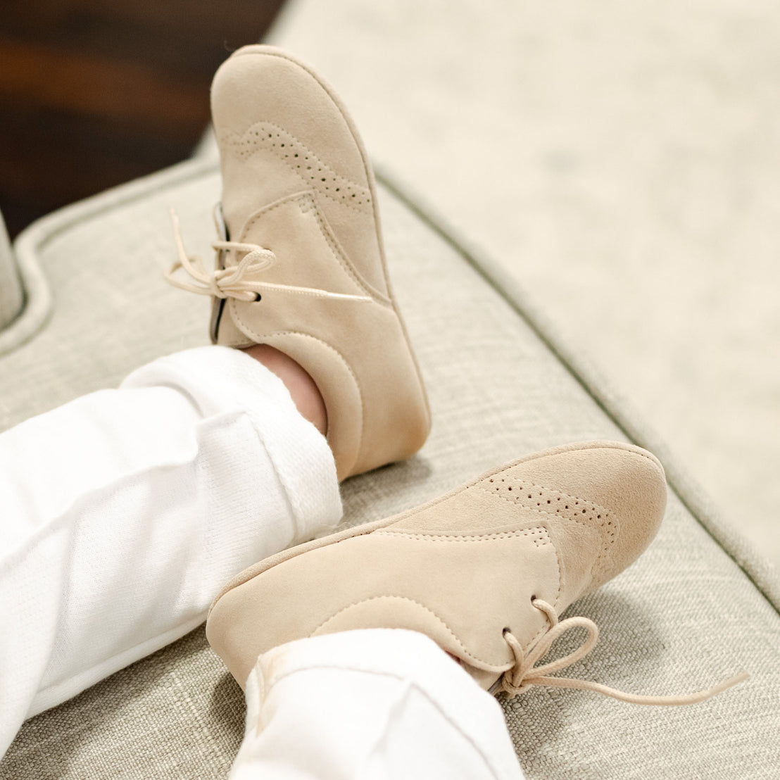 Baby boy wearing the Theodore Suede Shoes in camel (or tan).