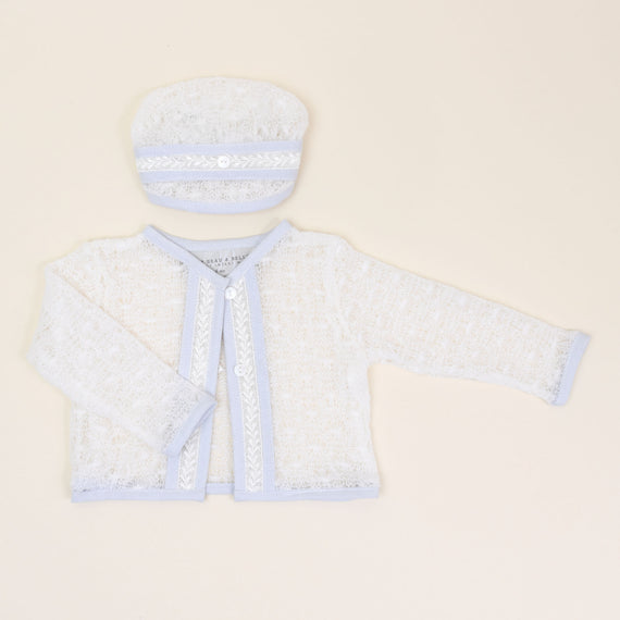 Flat lay photo of the Harrison Off-White Knit Christening Hat and Sweater. Made with custom off white knit and ivory Venice trim down the center with buttons