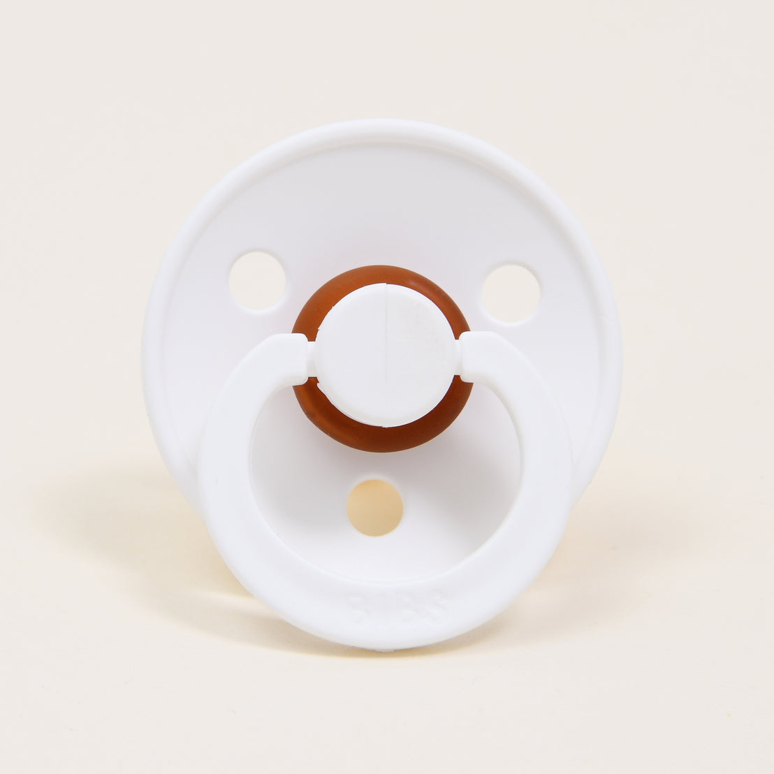 Introducing the Harrison Pacifier Set in White & Baby Blue: This pacifier features a circular shield with two side holes, a brown accent around the center, and is crafted from natural rubber. It is designed to aid babies in self-soothing. The handle is located at the bottom and is presented against a simple light background.