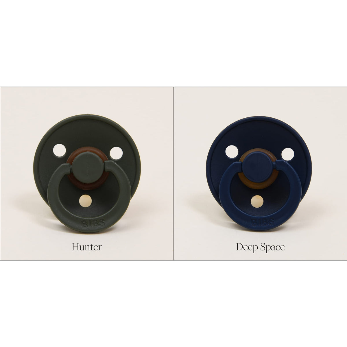 Against a plain background, two Bibs Pacifiers are showcased side by side. The left pacifier, "Hunter," is made from natural rubber and comes in a soothing dark green shade, ideal for self-soothing. The right pacifier, labeled "Deep Space," features a calming dark blue hue. Both pacifiers exemplify Danish quality for assured safety and comfort.