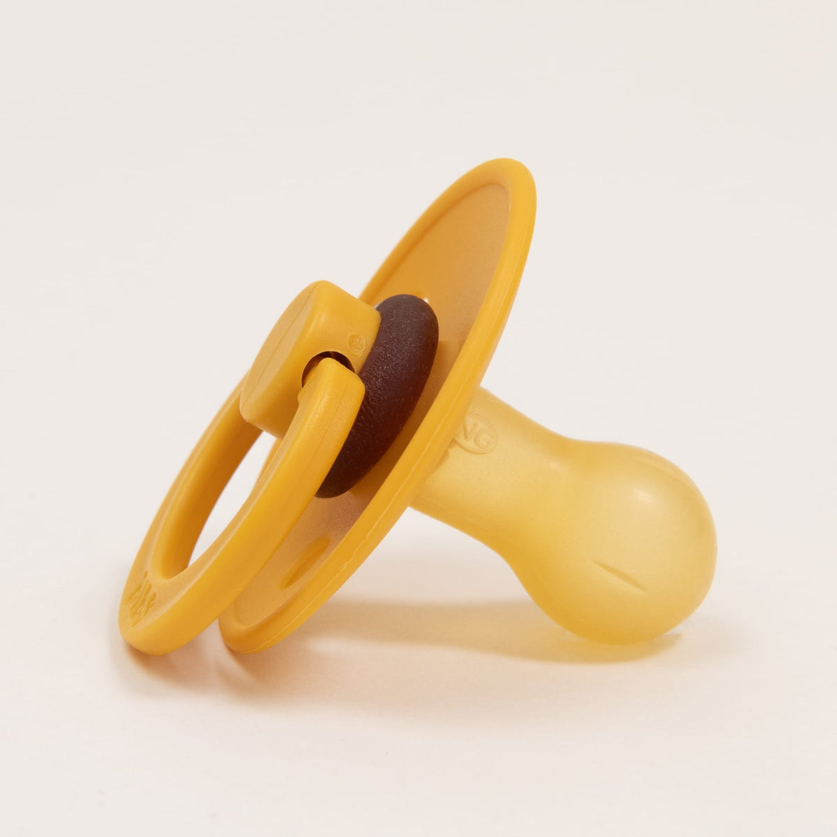 A Bibs Pacifier in Honey Bee color, made from natural rubber and featuring a ring handle to aid infants in self-soothing, is displayed against a plain white background. Crafted in Denmark, it exudes the simplicity and elegance typical of Scandinavian design.