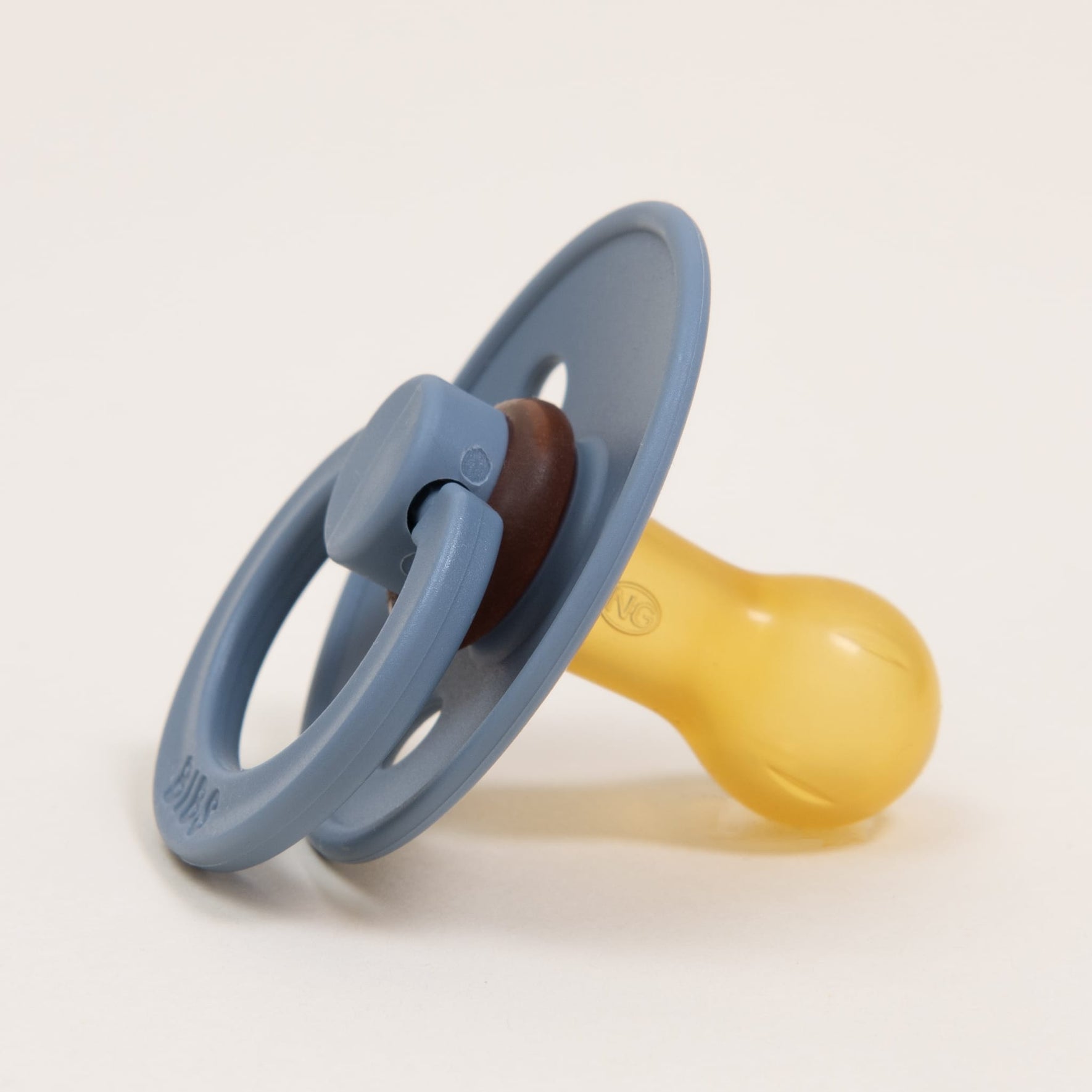 The Bibs Pacifier 2 Pack | Petrol, made from natural rubber in Denmark, features a round handle and bulbous nipple in shades of blue and beige, resting on a neutral background. It's perfect for helping little ones self-soothe.