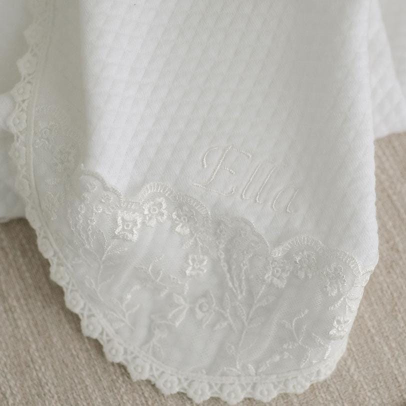 Close up photo showcasing the details of the Ella receiving blanket. 