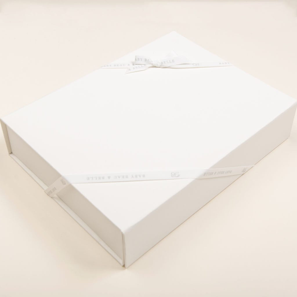 A small white rectangular keepsake gift box from Baby Beau & Belle, featuring a matching ribbon tied in a simple bow on top, is elegantly presented on a light, neutral background.