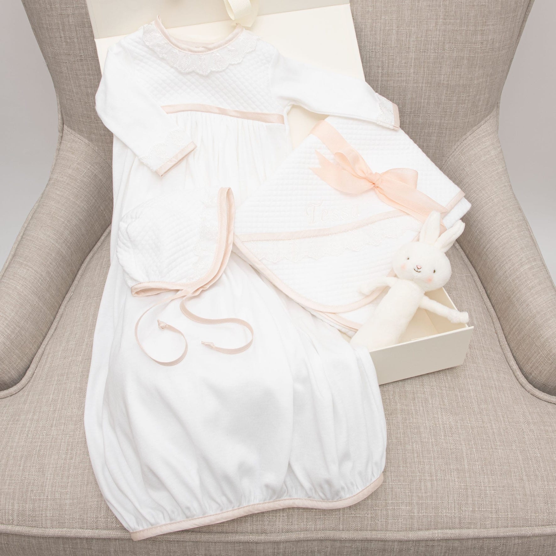 Photo showcasing what is in the Tessa Newborn Gift Set, including the Layette Gown, Bonnet, Bunny Chime, Blanket and Gift Box.